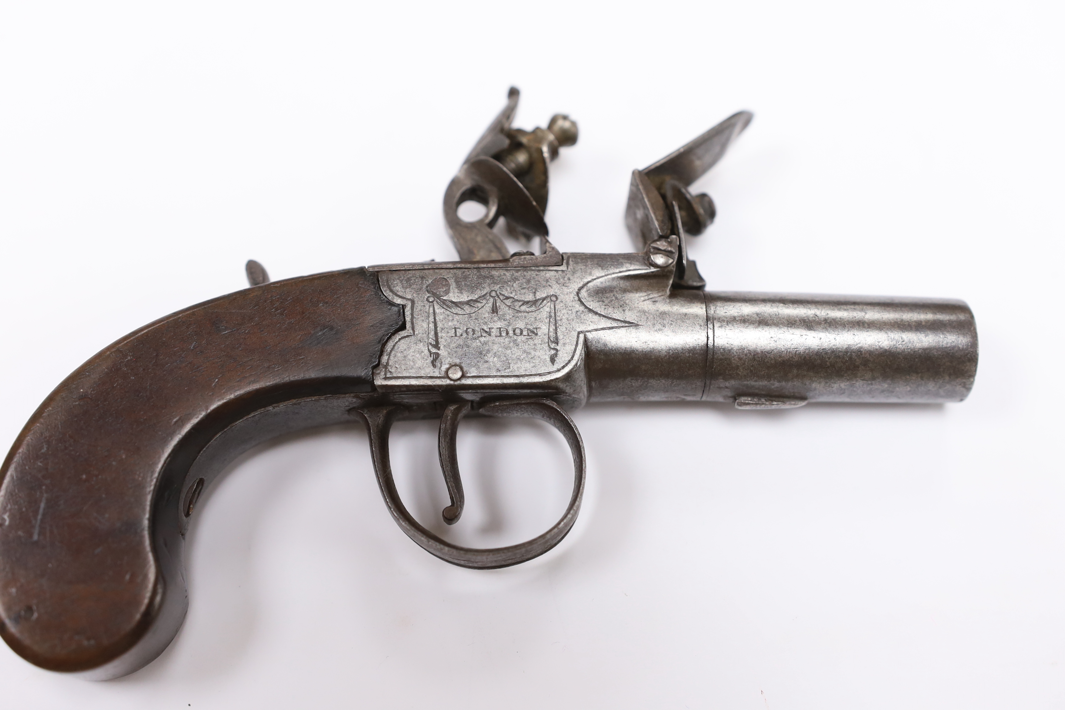 A small boxlock flintlock pistol by Perkins of London, with turn-off barrel, frame signed by the maker, with walnut slab grip, barrel 4.5cm